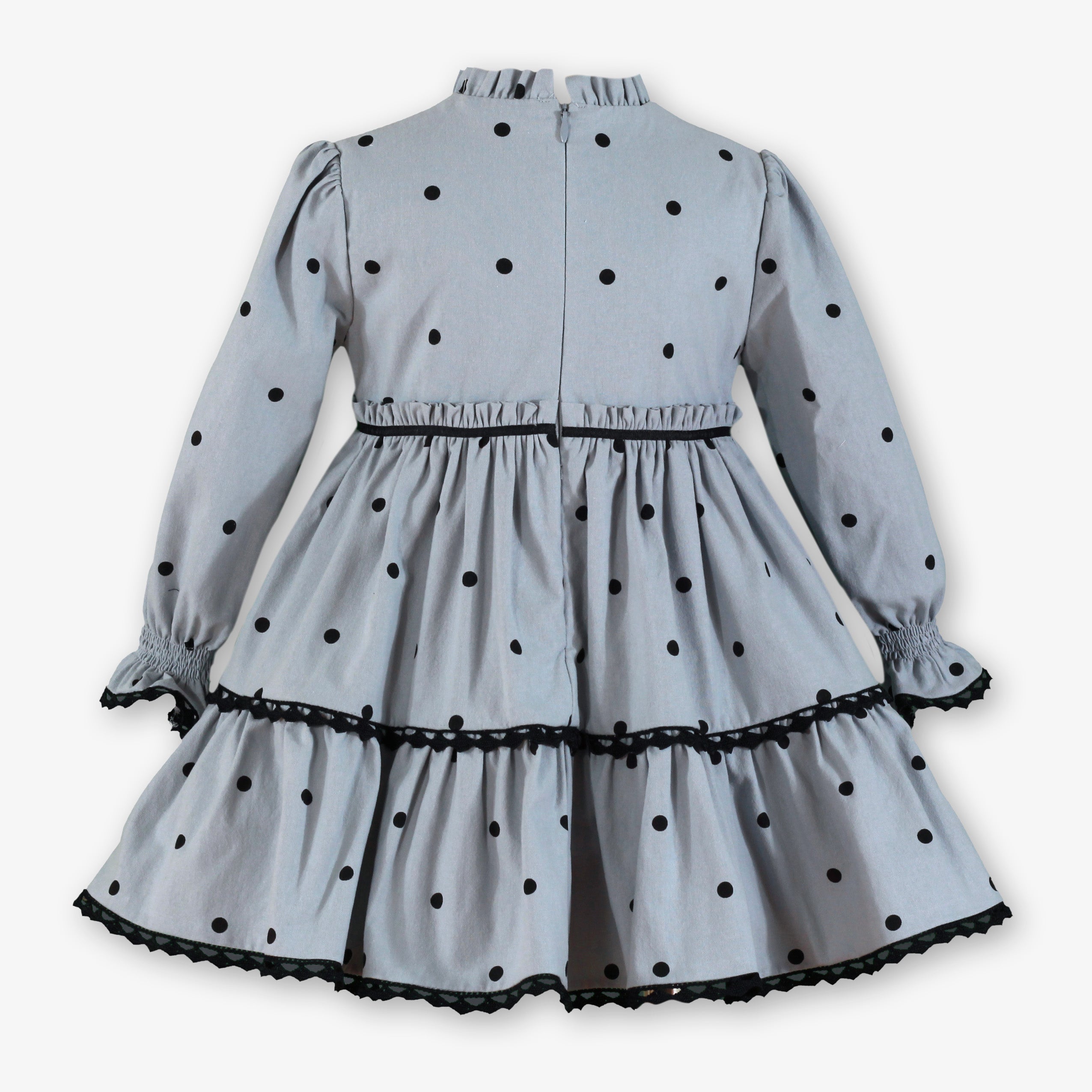 Vista trasera con cremallera invisible del vestido gris de lunares negros para niña firma Miranda