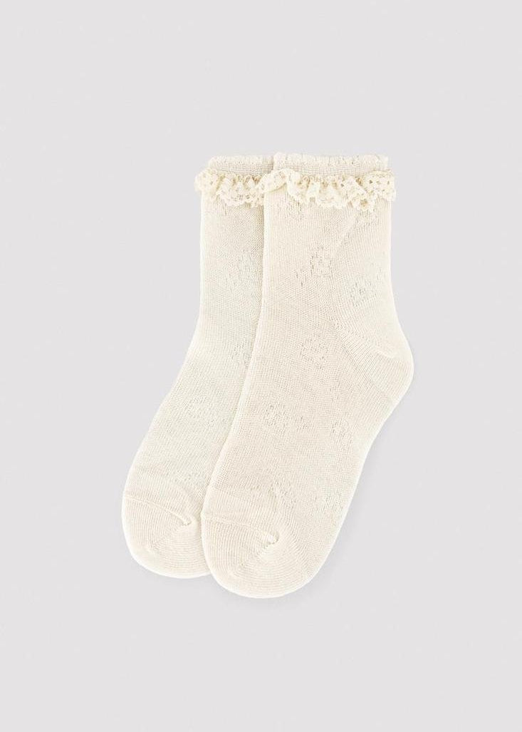 Calcetín infantil calado color marfil de Ysabel Mora con puño antipresión para eventos.