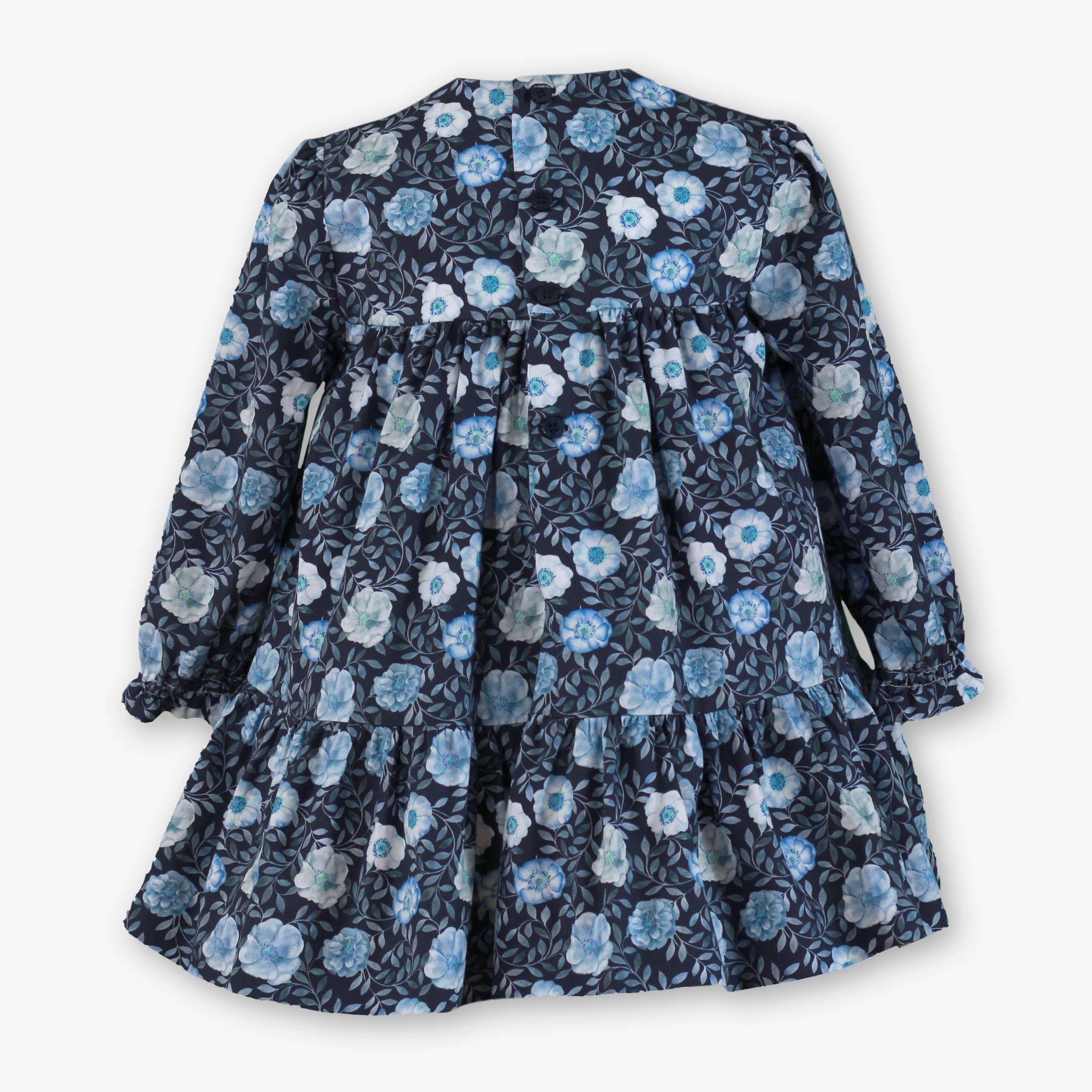 Vista trasera con botonadura del vestido floral azul marino para niña de la firma Miranda