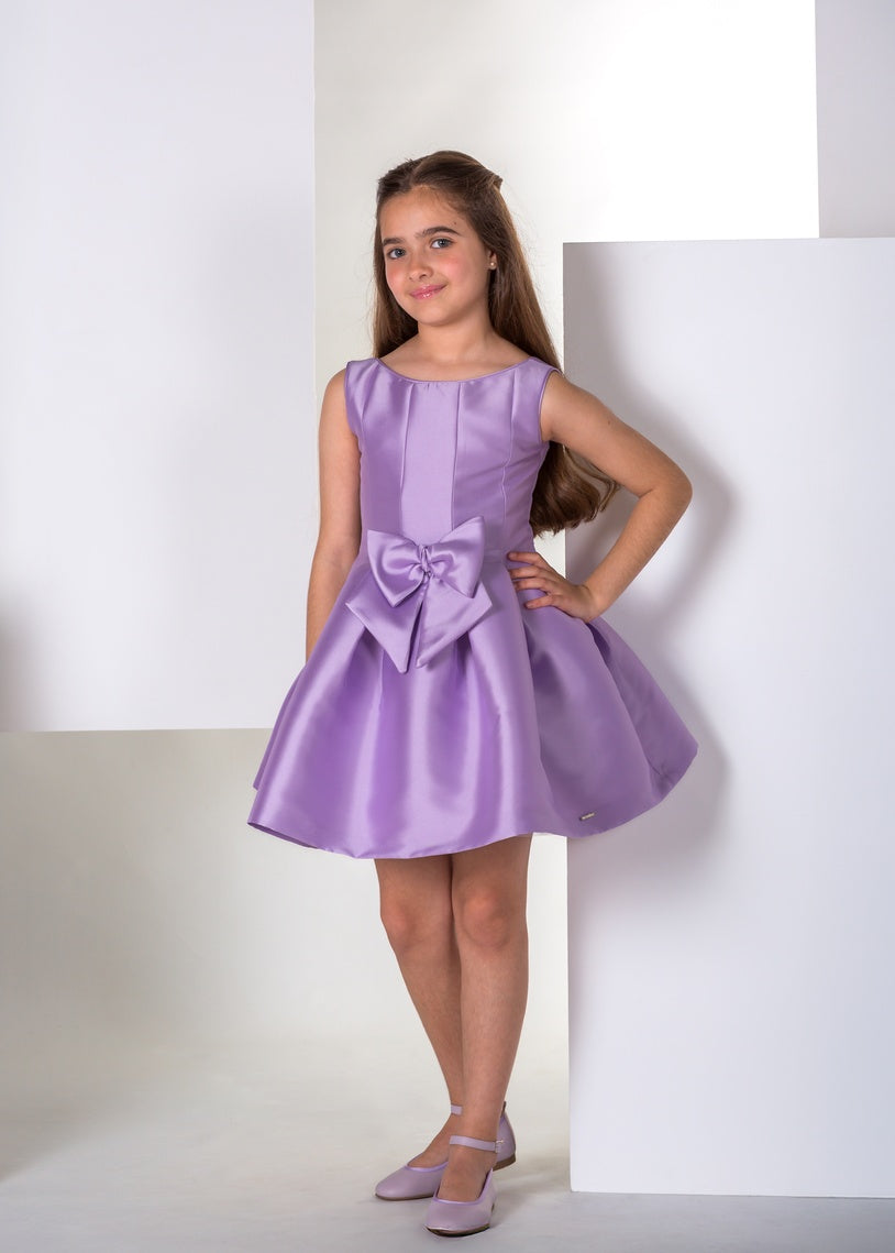 Vestido de ceremonia para niña modelo Eden de la marca Meninas en color malva con un gran lazo decorativo en el frontal.